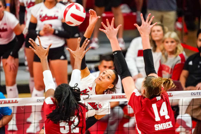 Nebraska Cornhuskers outside hitter Harper Murray attacks against Wisconsin's Carter Booth (52) and middle blocker Anna Smrek during the first set (Oct. 21, 2023).